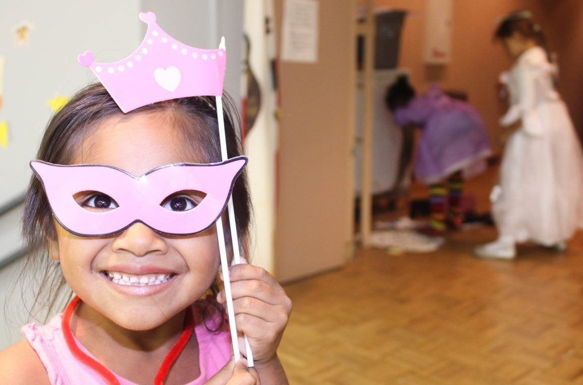 girl with pink princesses paper crown and mask